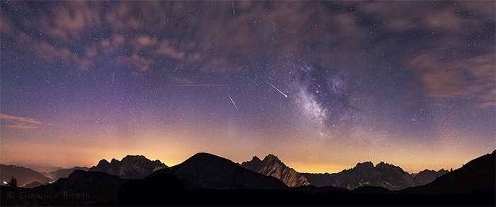 Don't forget to think about ambient light from nearby cities. In this photo, Gianluca Biondi has found an interesting perspective of the night sky which is complimented by the rim light the city is casting onto the mountain range. - Photo by Gianluca Biondi